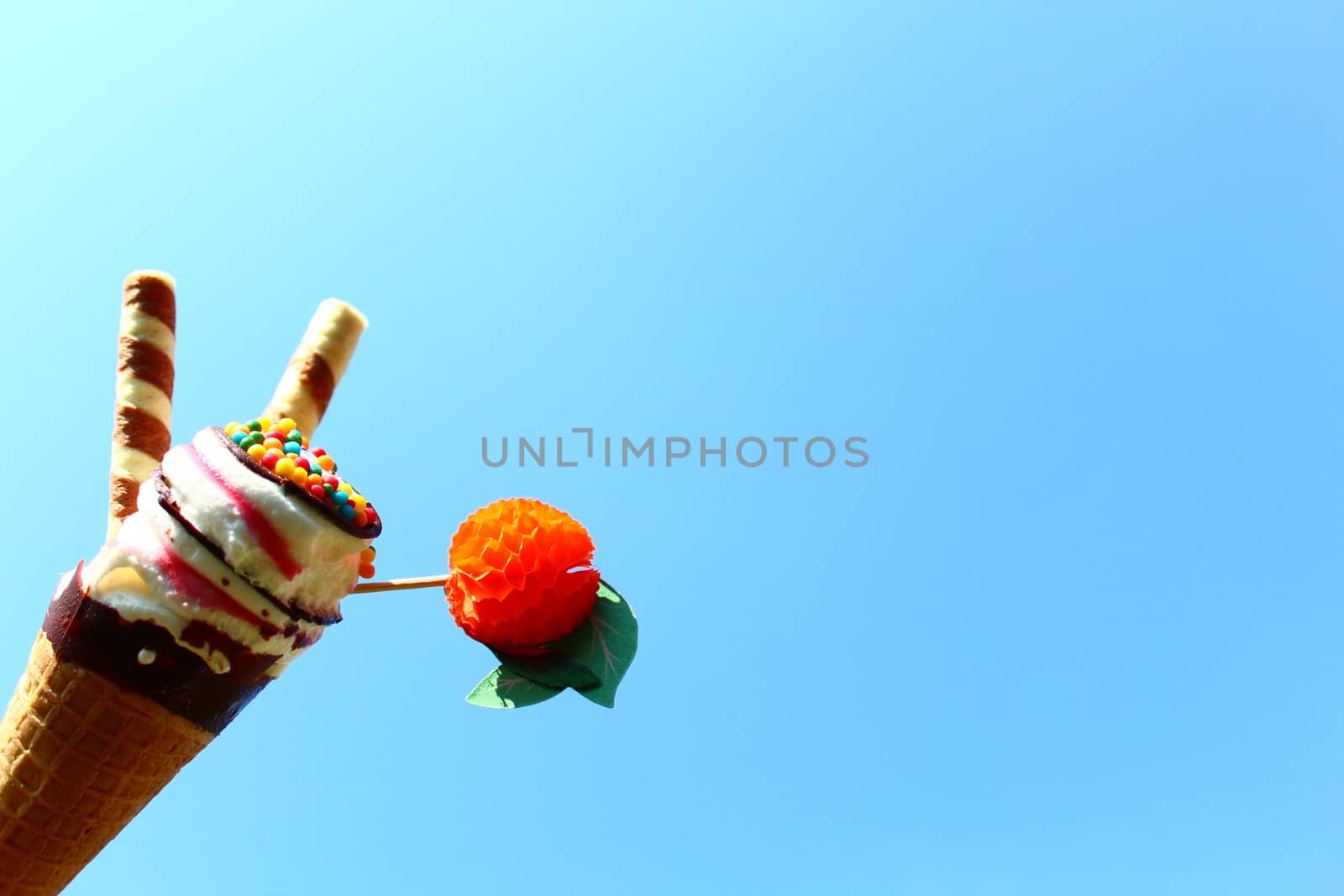 The picture shows an ice cream cone in front of the blue sky.