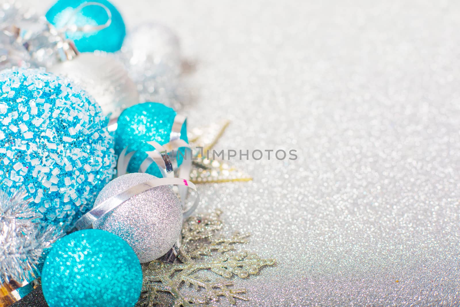 Christmas decoration of colorful glitter balls on silver glitter background with copy space for text new year card concept