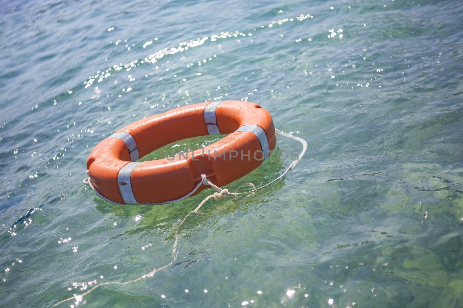 Life buoy on transparent sea for safe