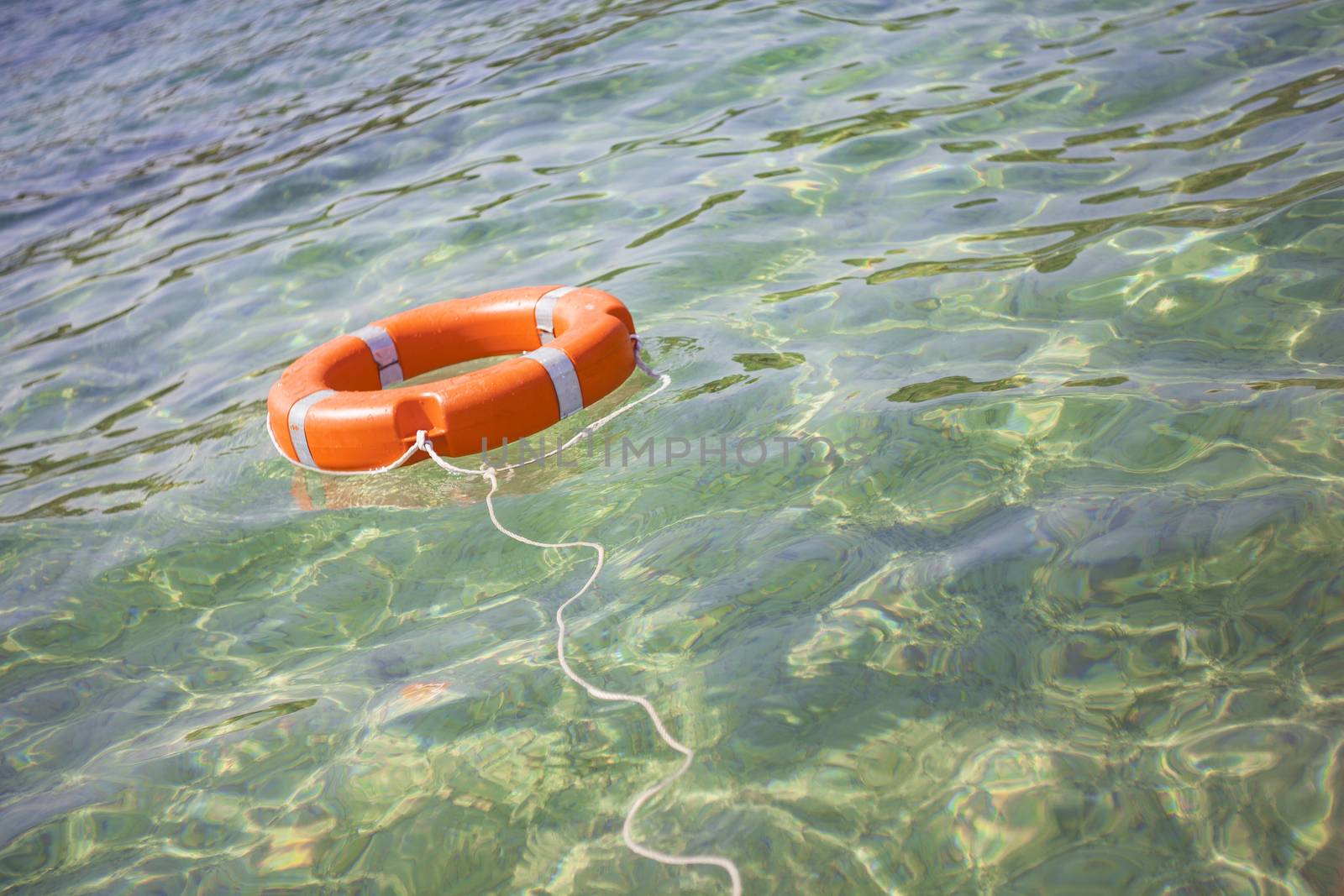 Life buoy on transparent sea for safe