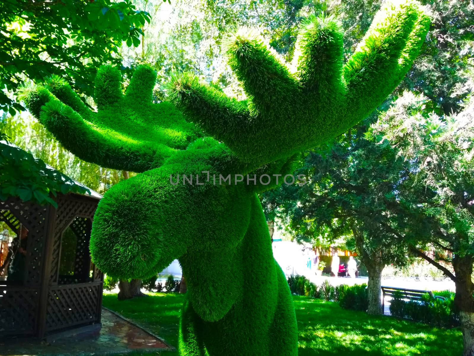 Elk head with horns of artificial grass green.