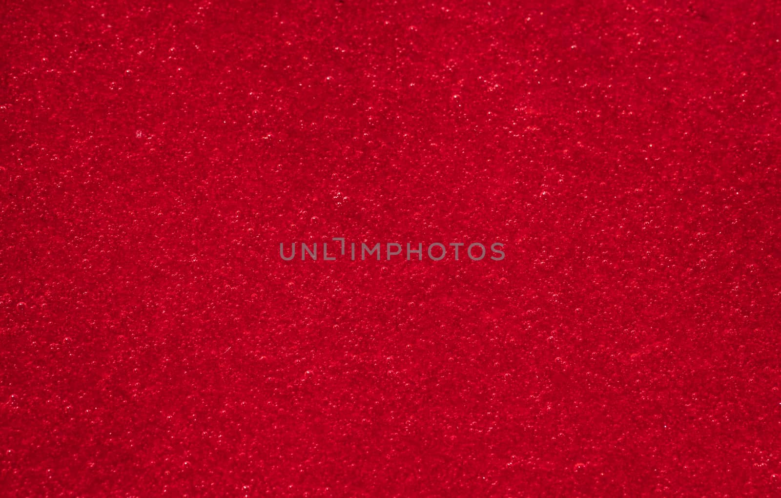 Viburnum berries juice with sugar as red background. Natural texture.