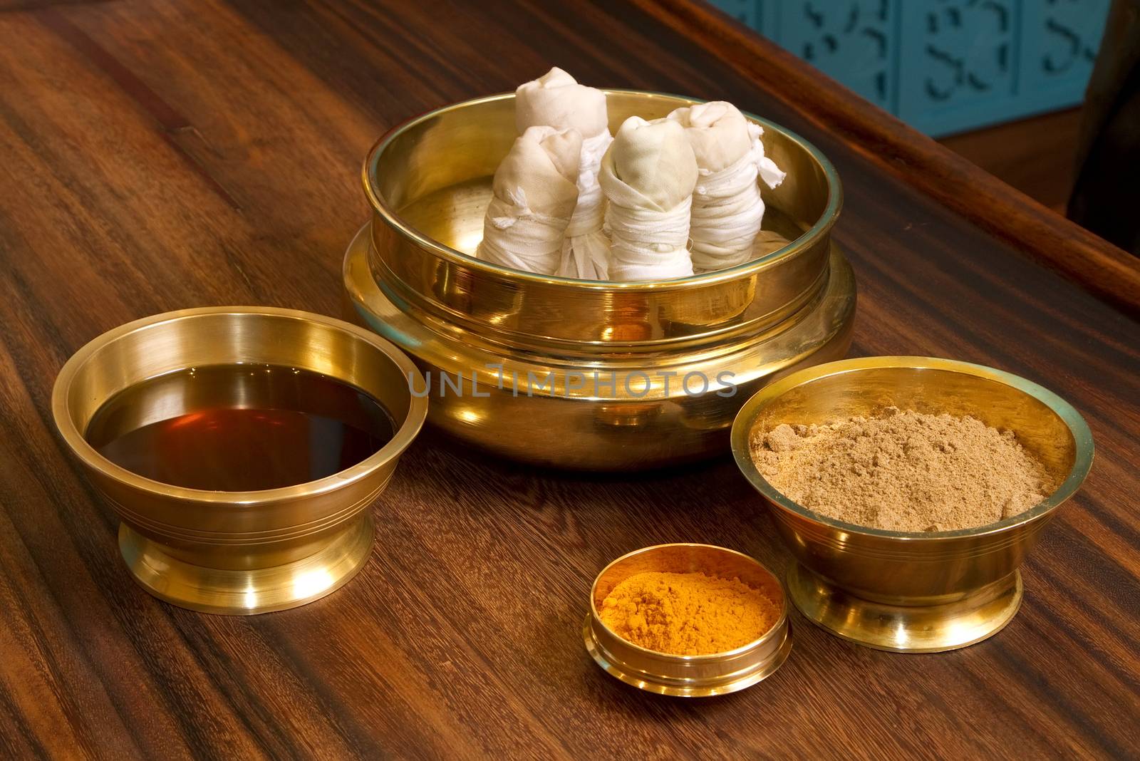  herbs powder and oil in bronze cups, prepared for  traditional indian ayurvedic  massage 