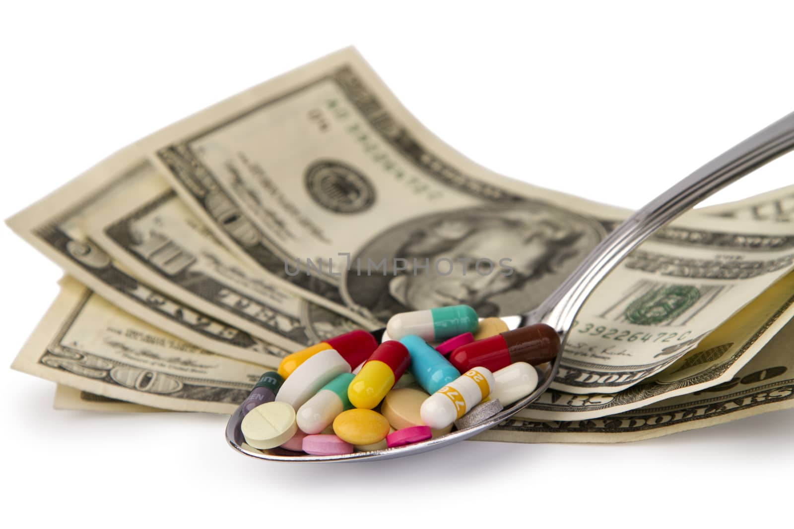 spoon full of tablets and a few dollars banknotes