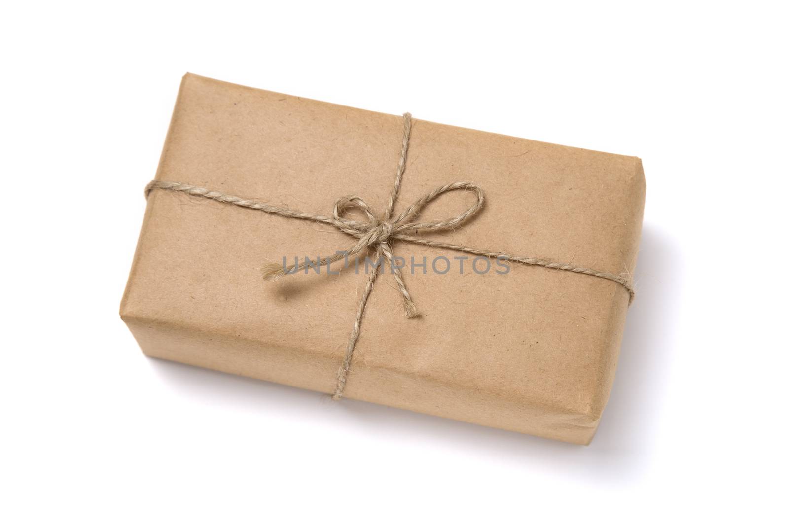 Christmas gift box wrapped in kraft paper. Isolated on white background
