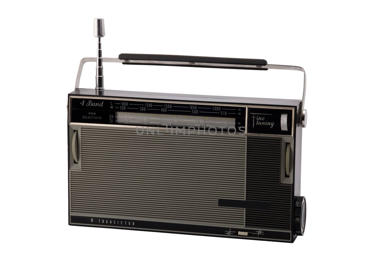 Old-fashioned transistor radio receiver, isolated on white background.