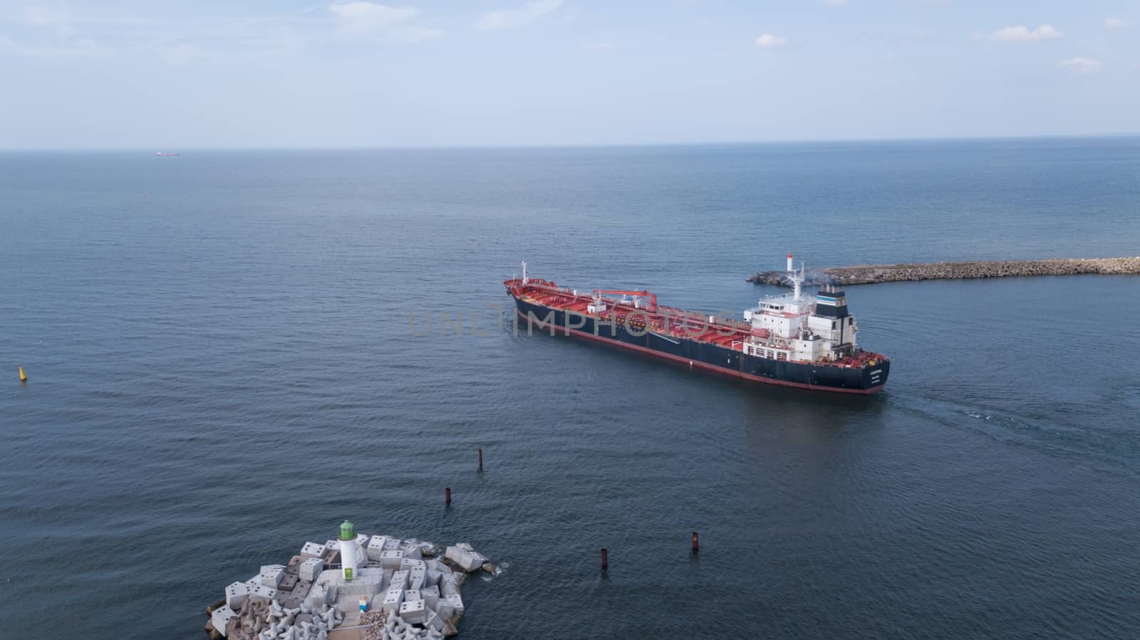 ship going in to Harbor Ventspils Latvia Aerial view of countryside drone top view