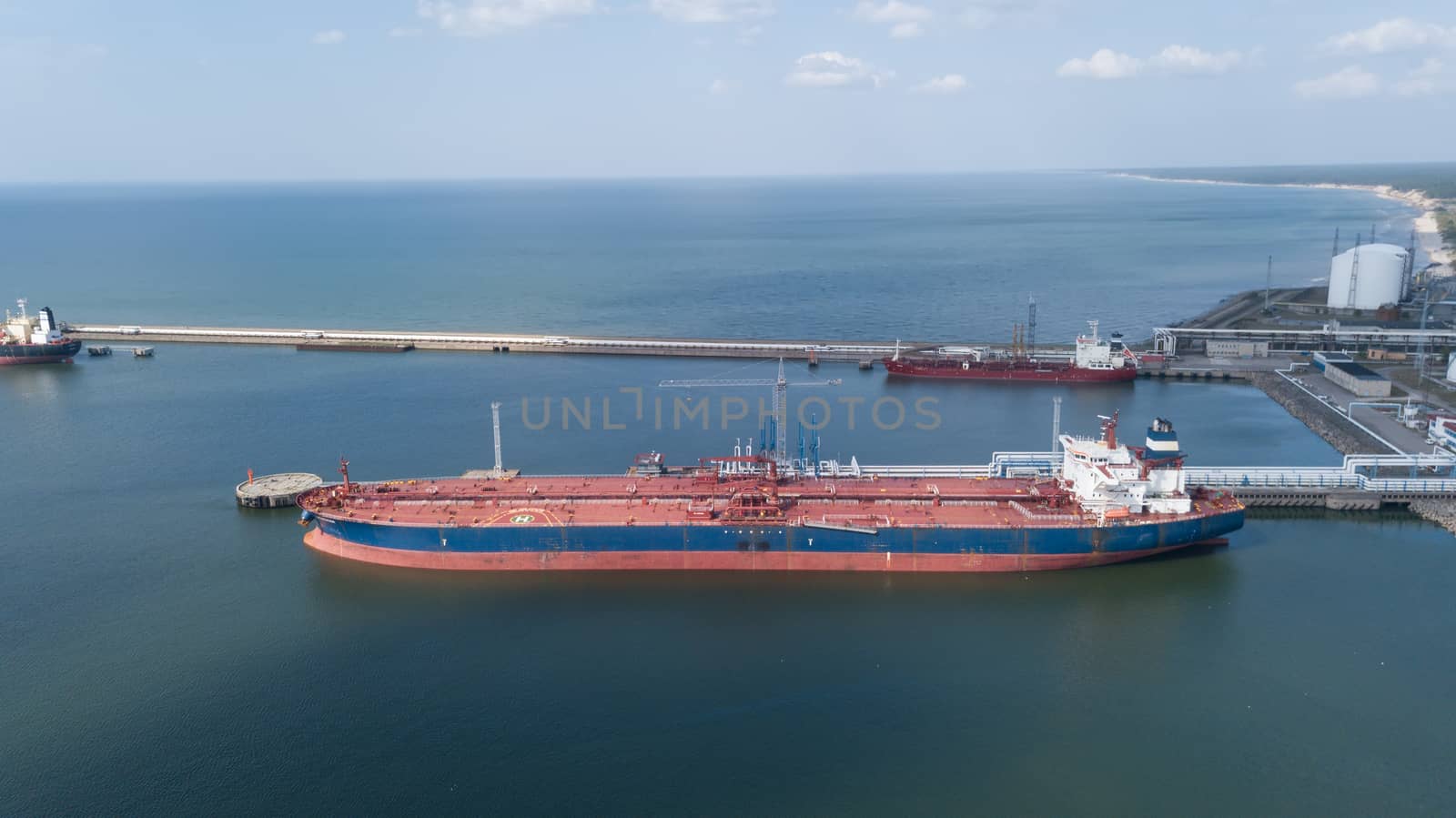 ship going in to Harbor Ventspils Latvia Aerial view of countryside drone top view by desant7474