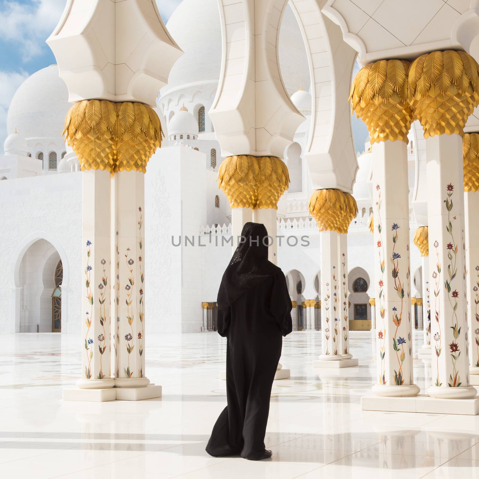 Traditionally dressed arabic woman wearing black burka wisiting Sheikh Zayed Grand Mosque in Abu Dhabi, United Arab Emirates by kasto
