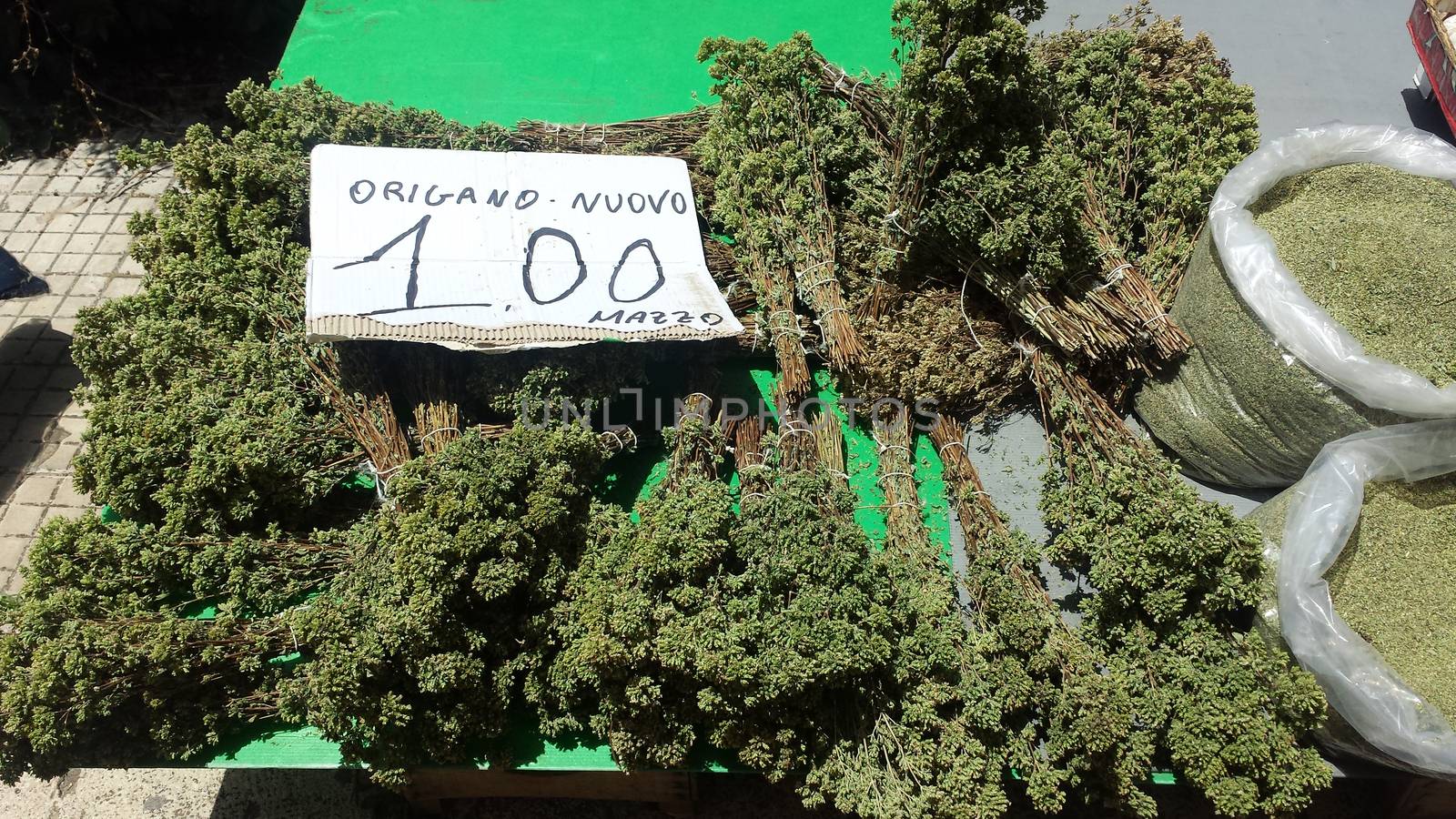 bundles of oregano for sale on the Sicilian market counter in Palermo