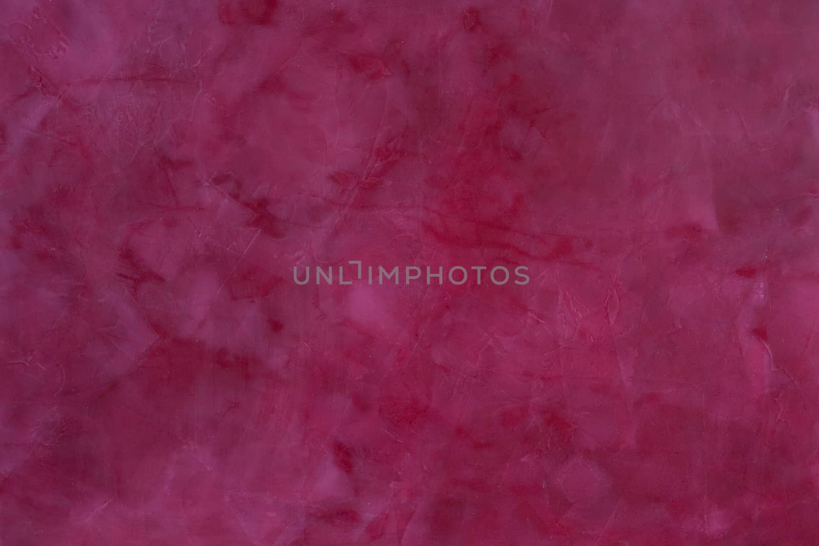 painted,  layered surface of the wall in magenta and red  tones