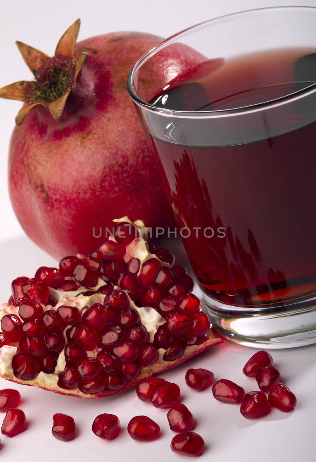 fresh ripe pomegranate and juice in the glass