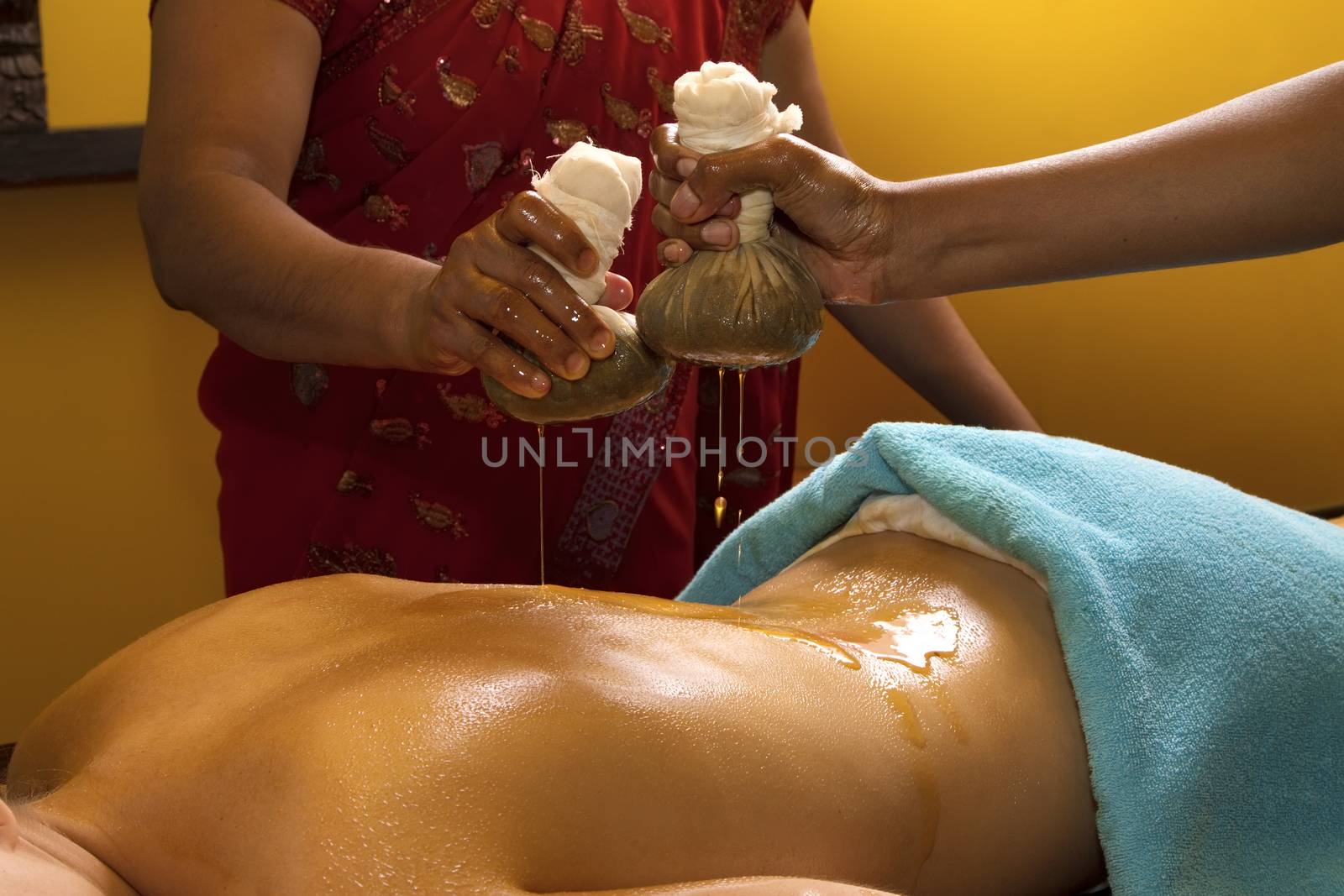  indian doctors doing traditional ayurvedic oil back massage