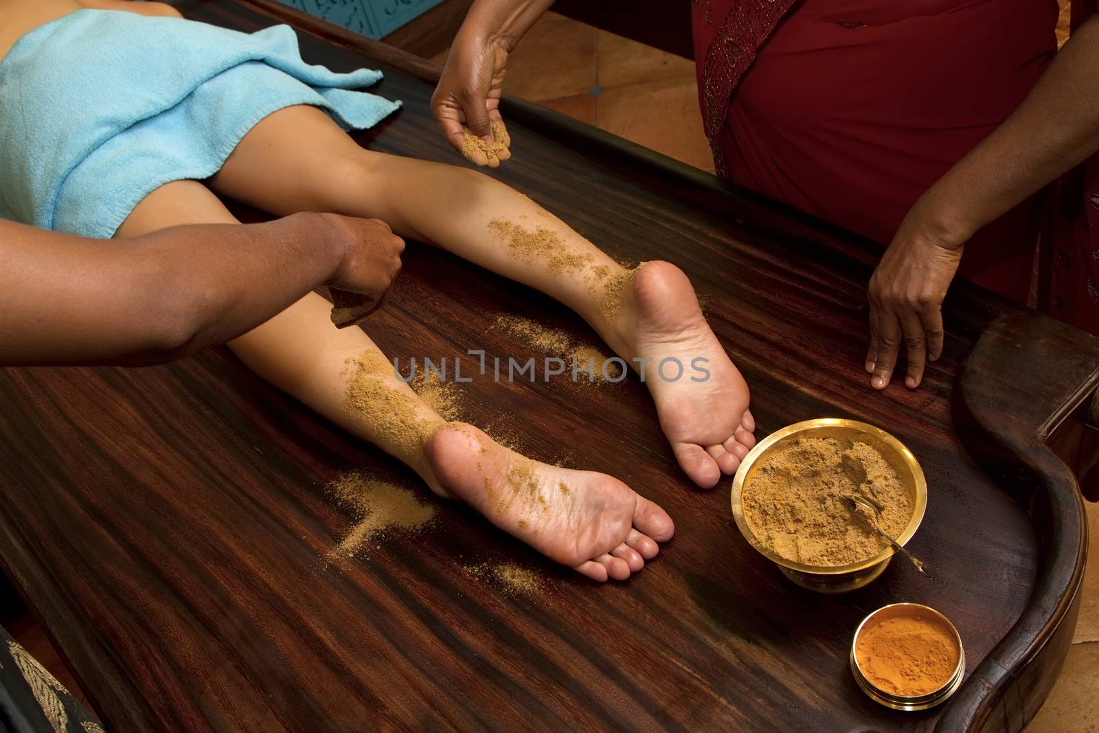   indian doctors doing traditional ayurvedic oil foot massage