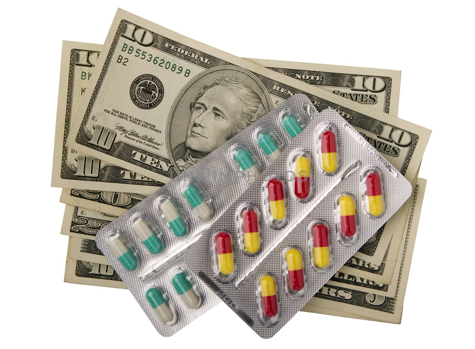 tablets in packs  against dollar banknotes, isolated on white
