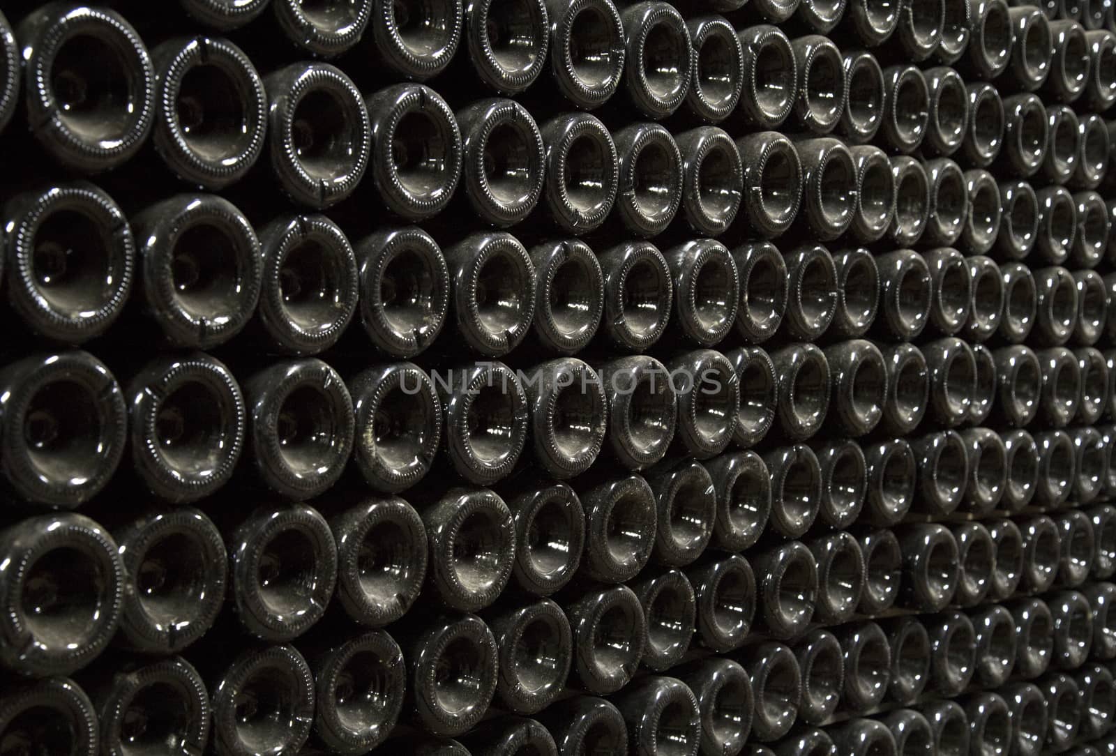 Close up image of champagne bottles in a wine rack while they ferment.