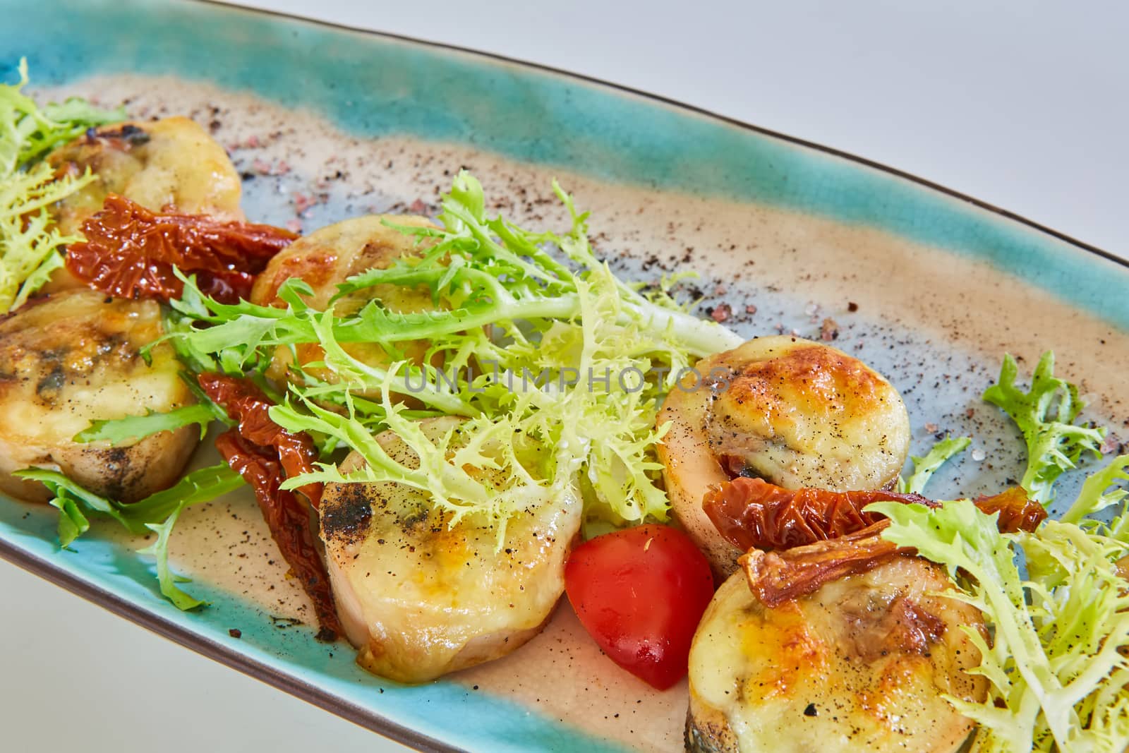 Fried scallops with butter lemon spicy sauce served with green salad. Top view, copy space