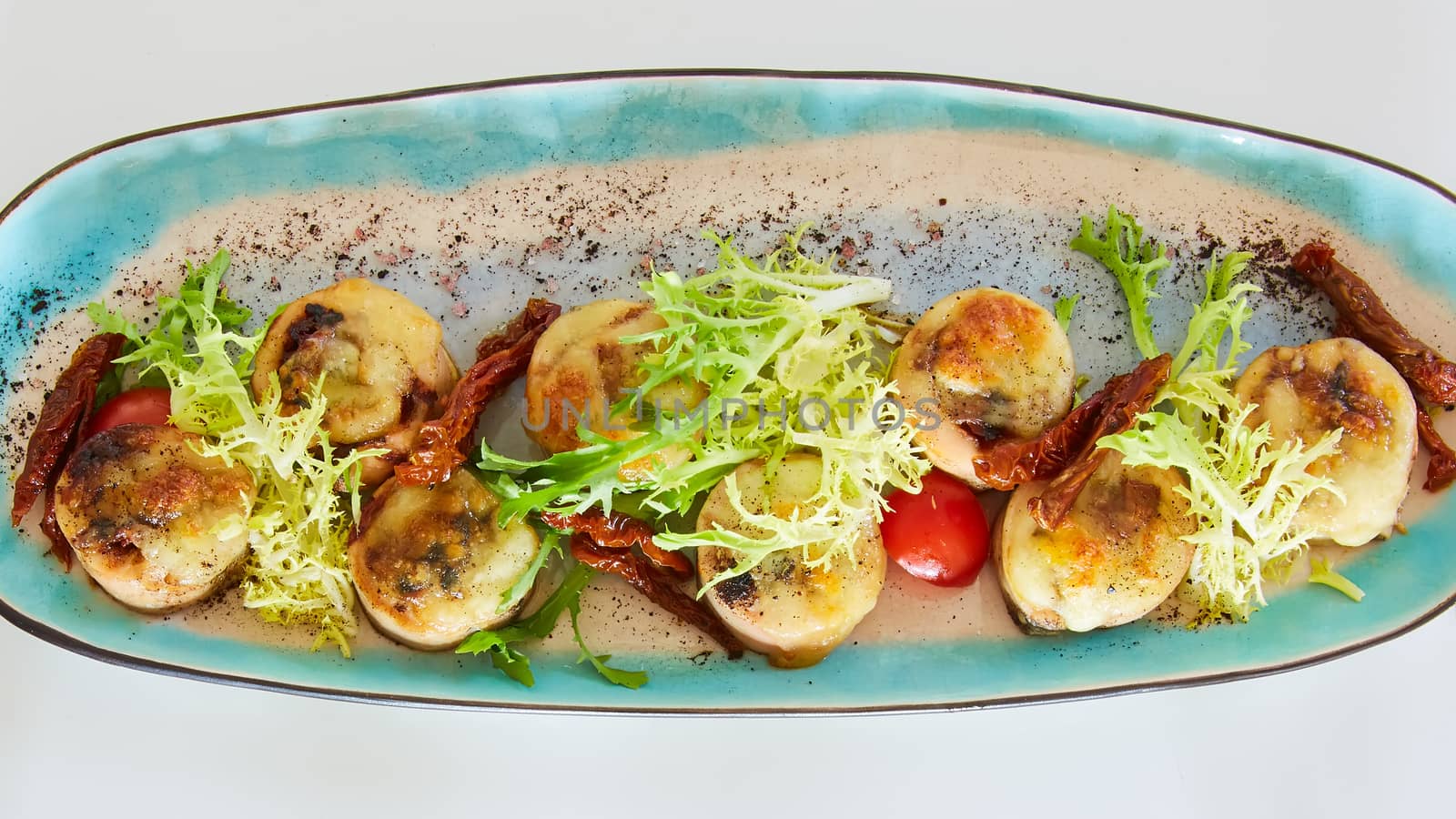 Fried scallops with butter lemon spicy sauce served with green salad. Top view, copy space. by sarymsakov