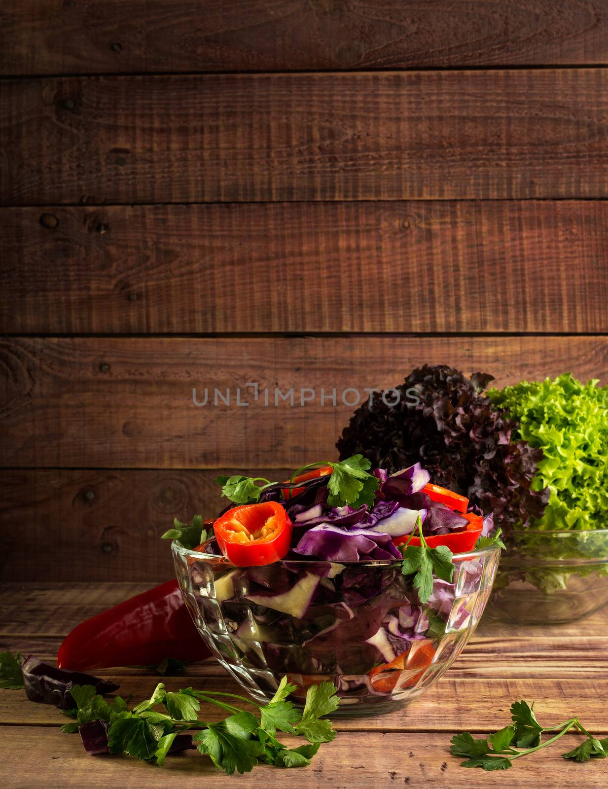 salad with vegetables and greens on table by dmitry_derenyuk