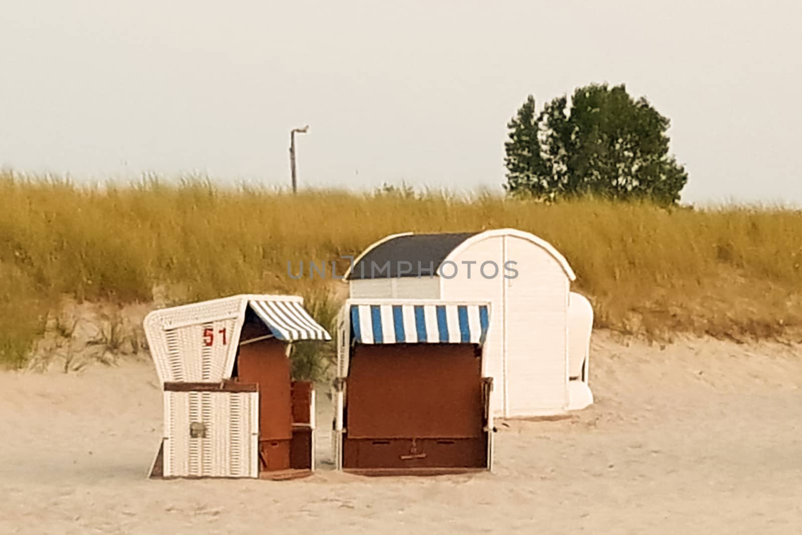 A group of beach chairs - beach chairs on beautiful beach with sand dunes in the background at blue sky - luxury vacation