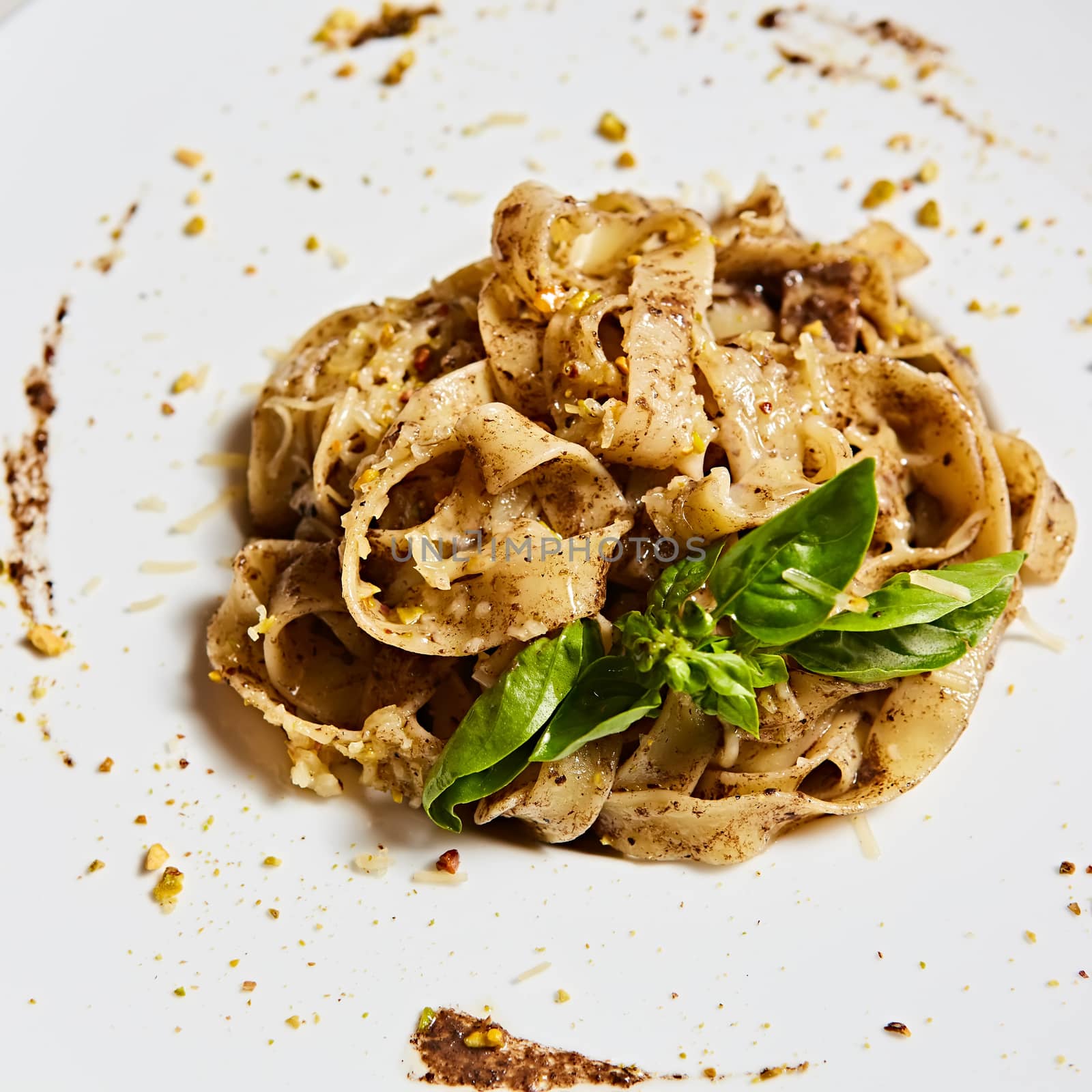 Tagliatelle with mushrooms and decorated with basil leaves
