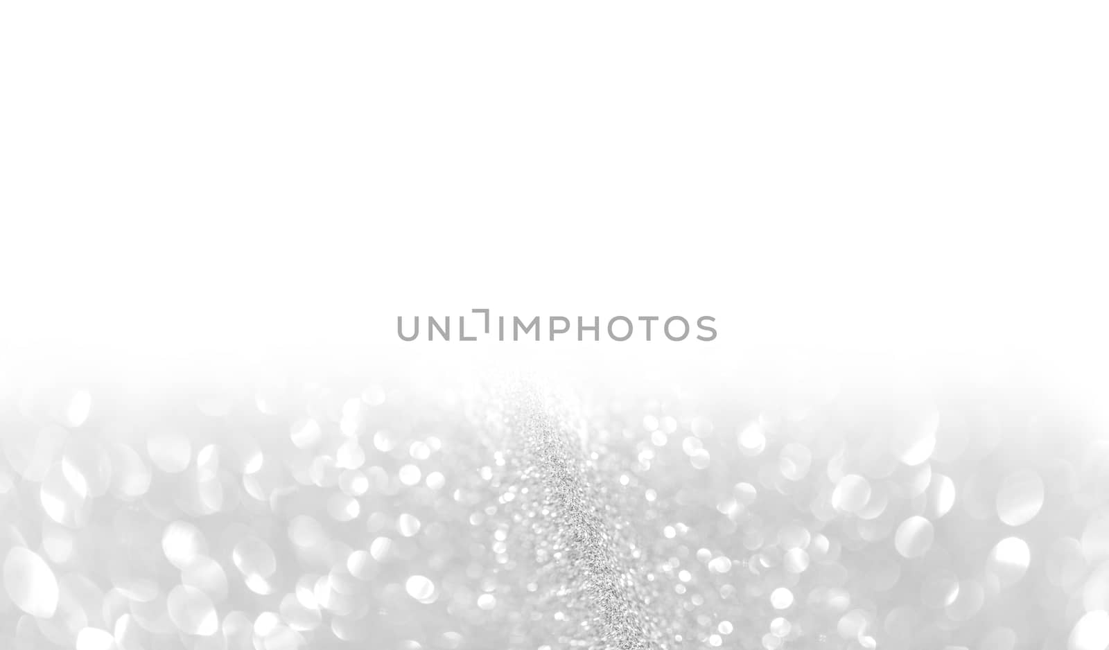 Silver festive glitter background with defocused lights , white copy space