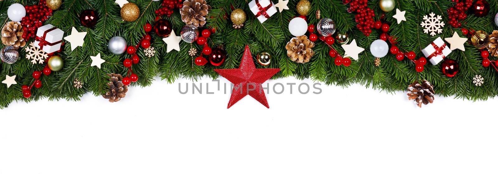 Christmas Border frame of tree branches on white background with copy space isolated, red and golden decor, berries, stars, cones