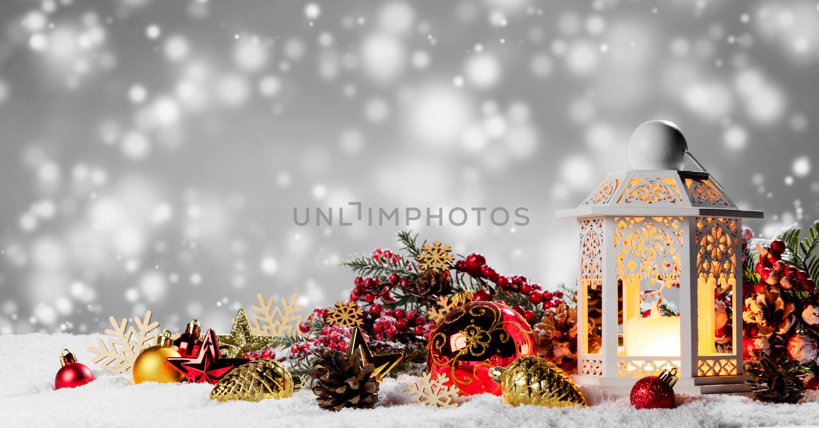 Burning candles , lantern and christmas decoration on magic bokeh lights background