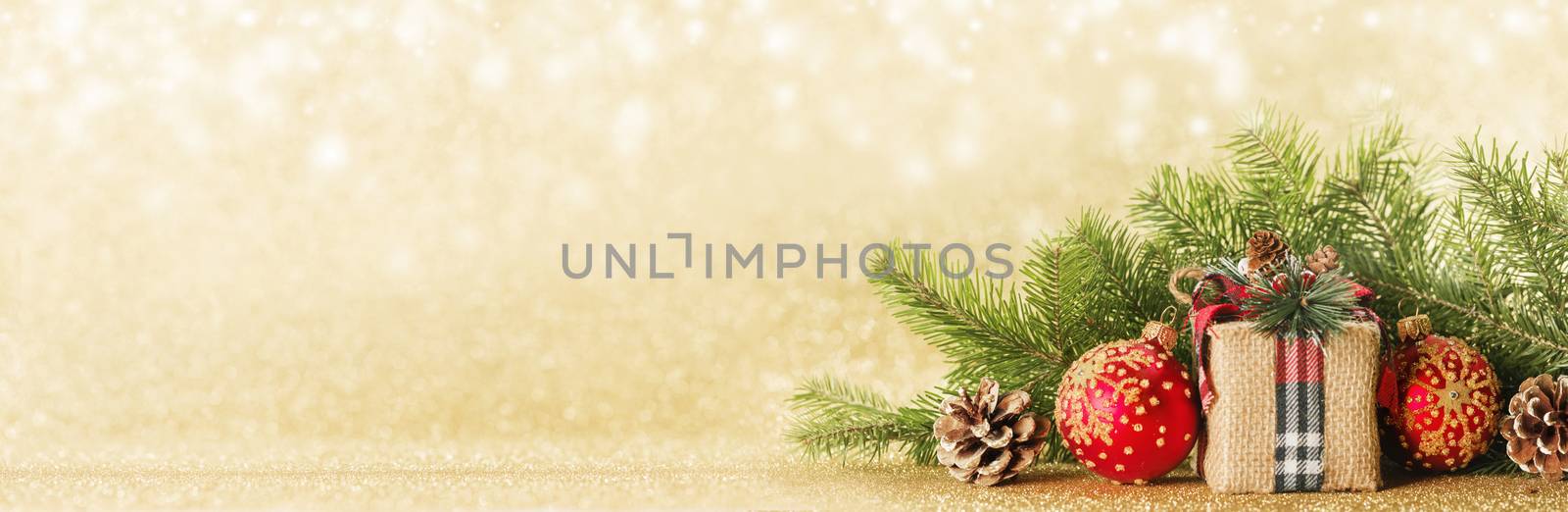 Christmas toys, decorations, present gift box wrapped in kraft paper on golden glitter background, copy space