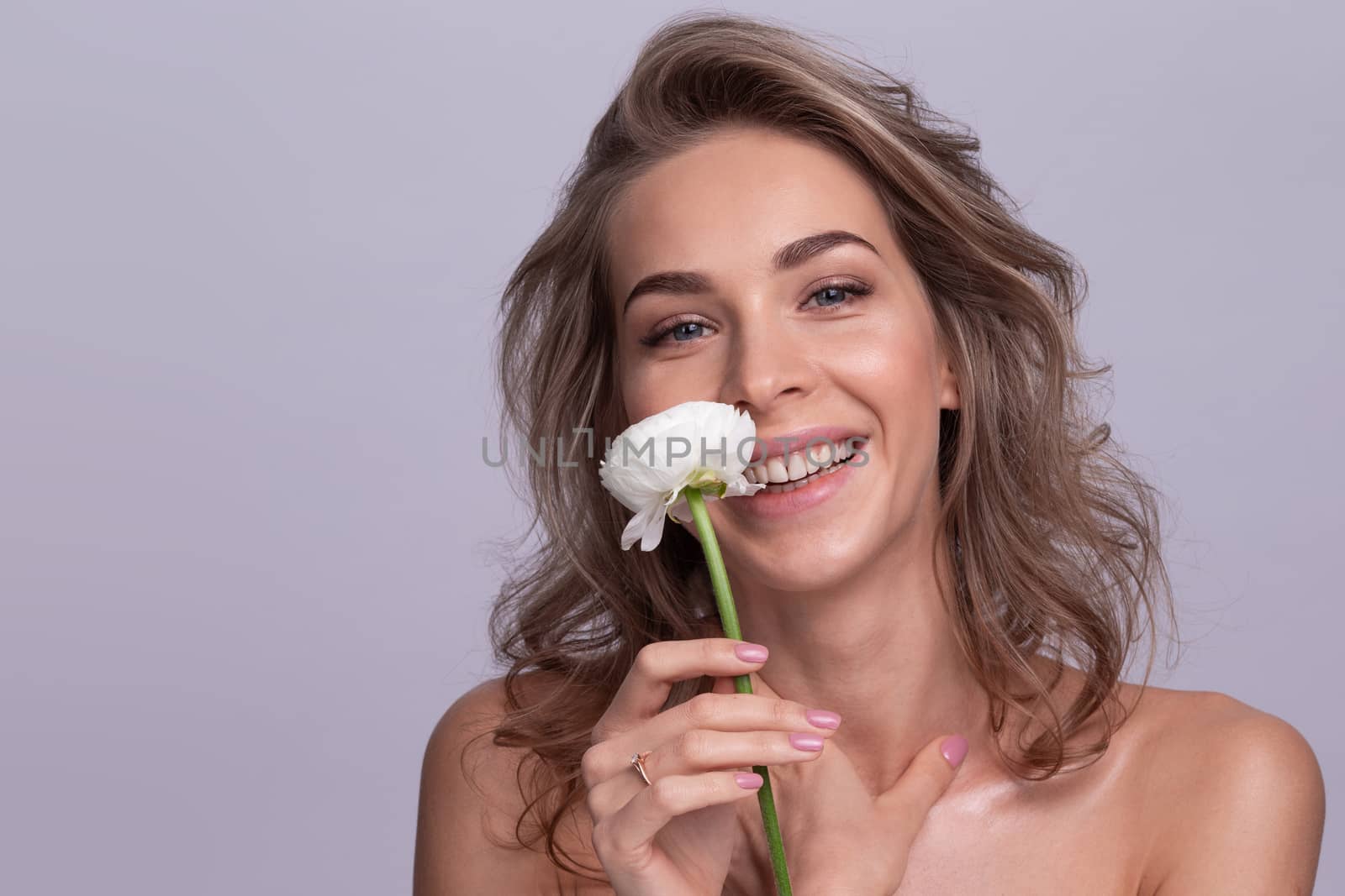 Portrait of beautiful blonde woman with white rose