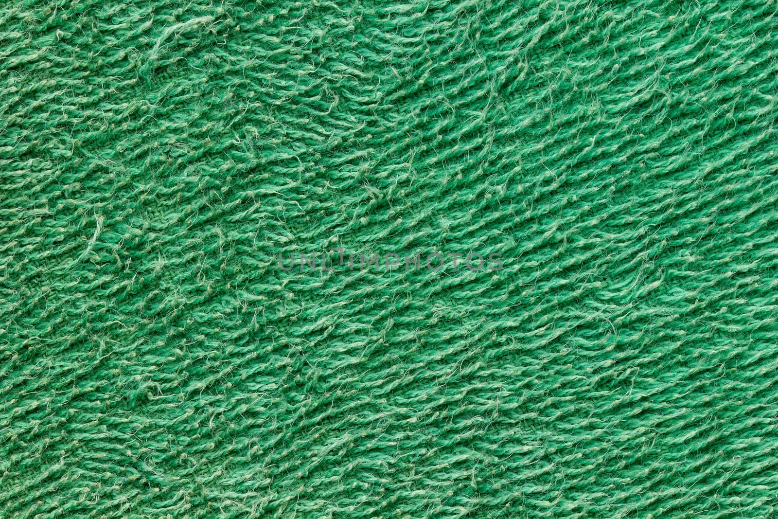 Texture of green towel fur. Concept of clothes or fashion.