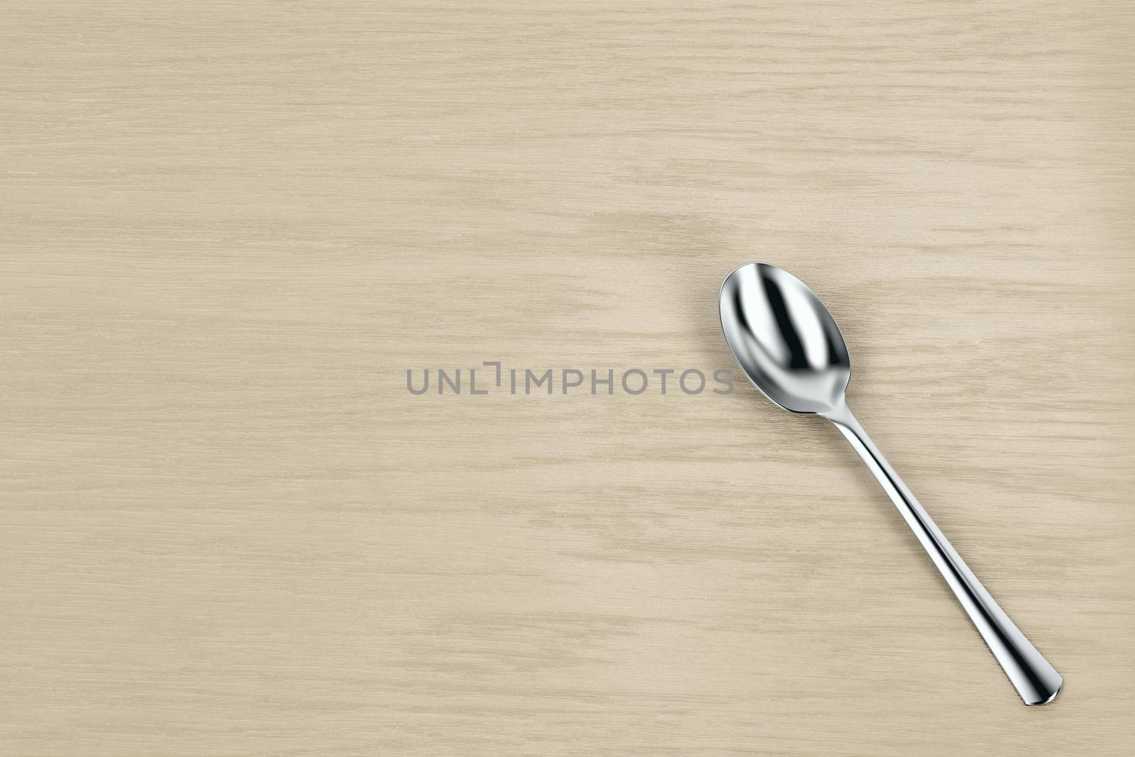 Silver spoon on wooden table, top view