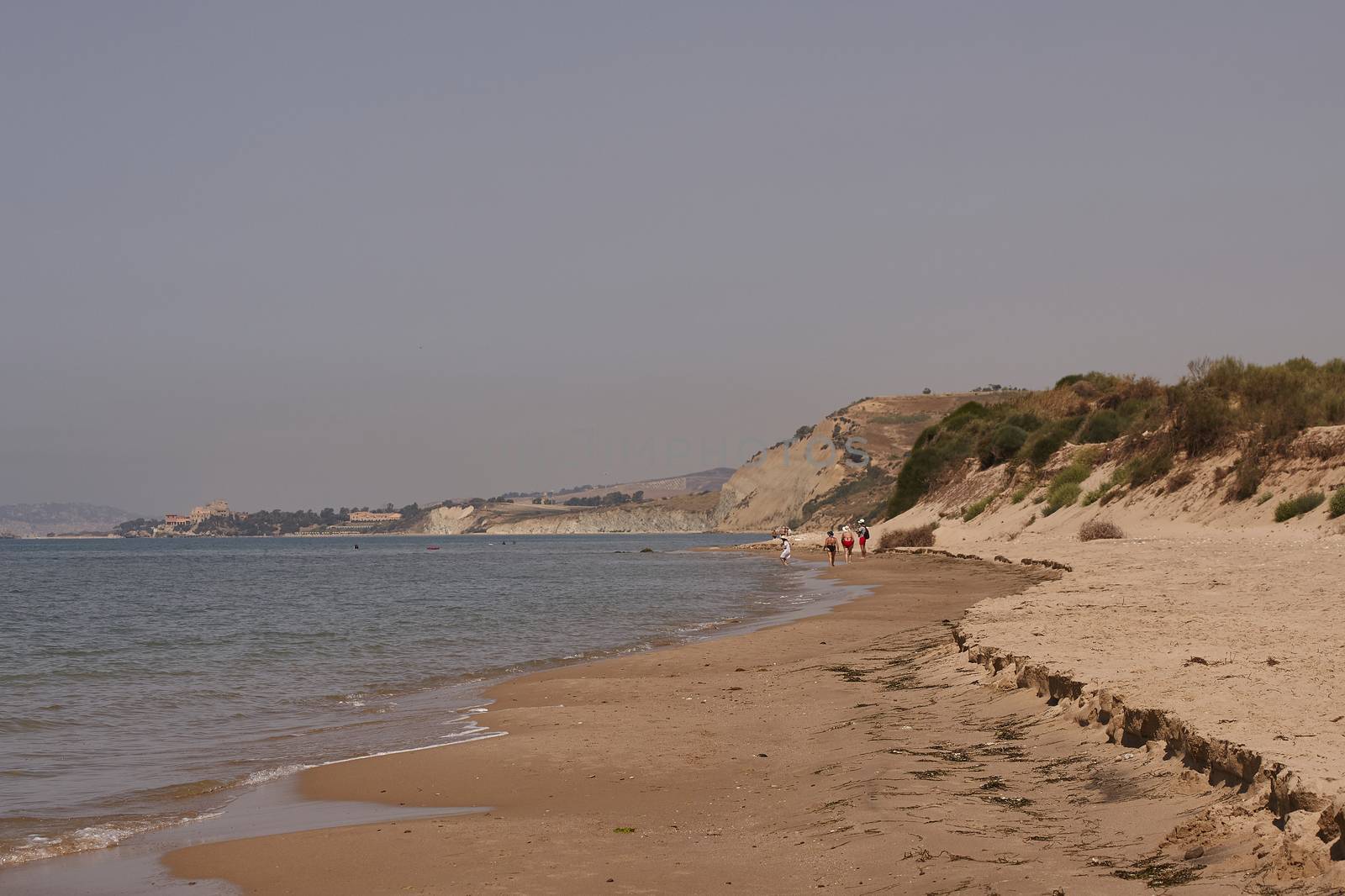 People walking on a beach in Marina di Butera, Sicily