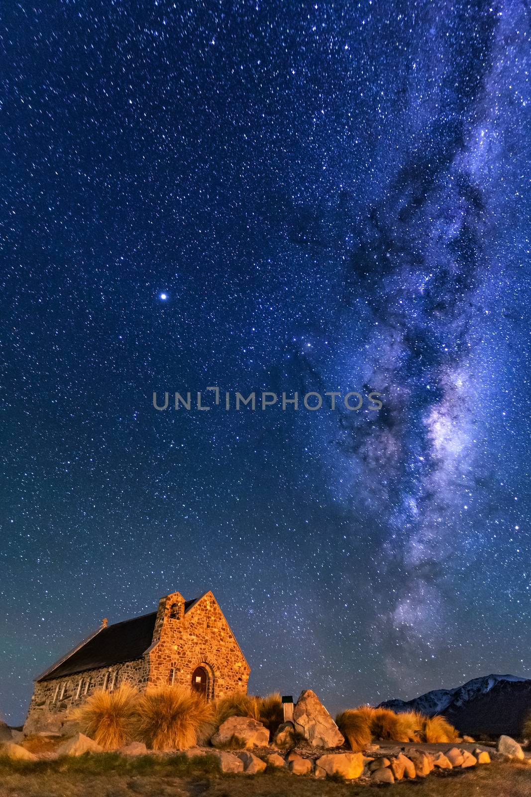 Milky Way Rising Above Church Of Good Shepherd, Tekapo NZ with Aurora Australis Or The Southern Light Lighting Up The Sky . Noise due to high ISO; soft focus / shallow DOF due to wide aperture used.