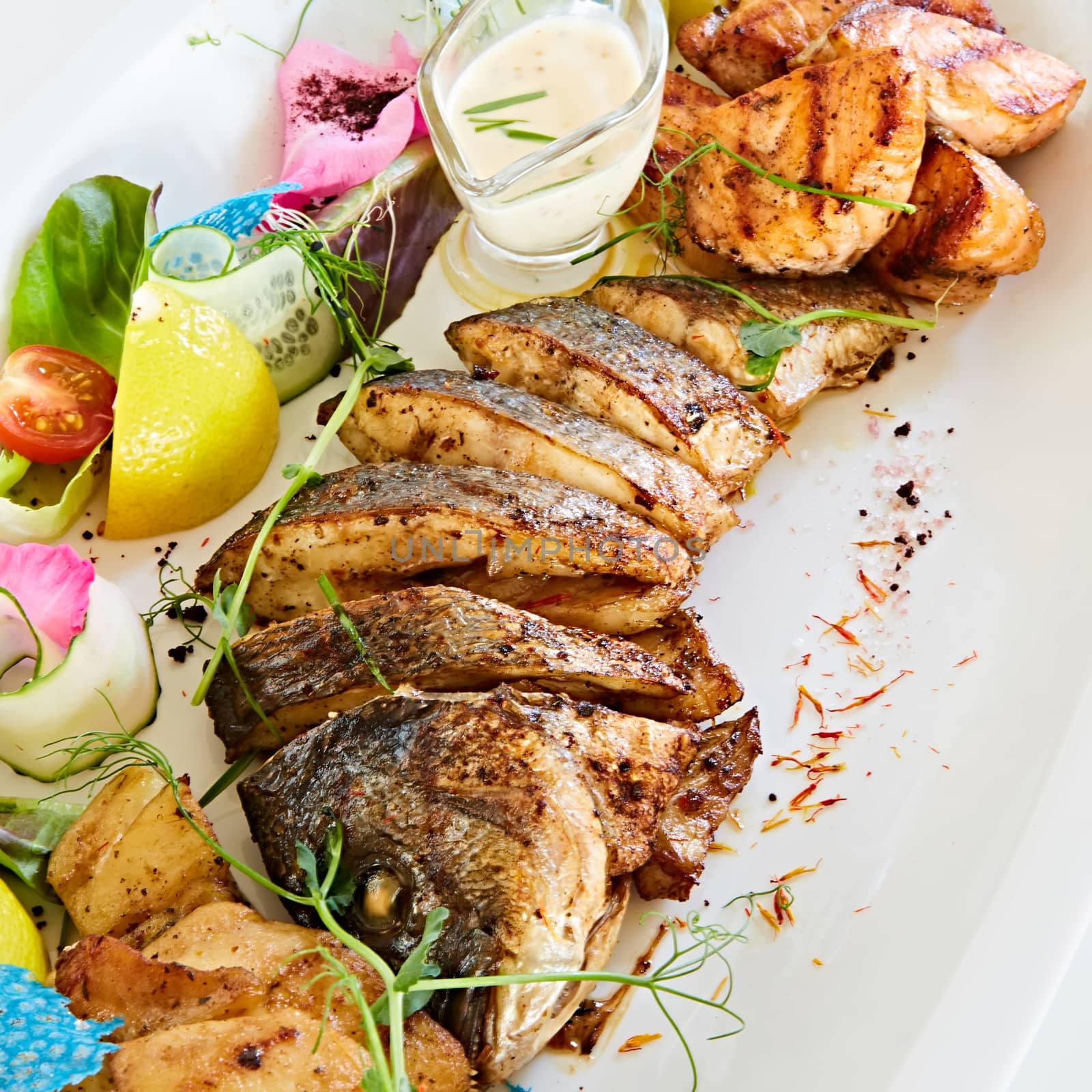 The fried fish on plate with vegetables. Shallow dof. by sarymsakov