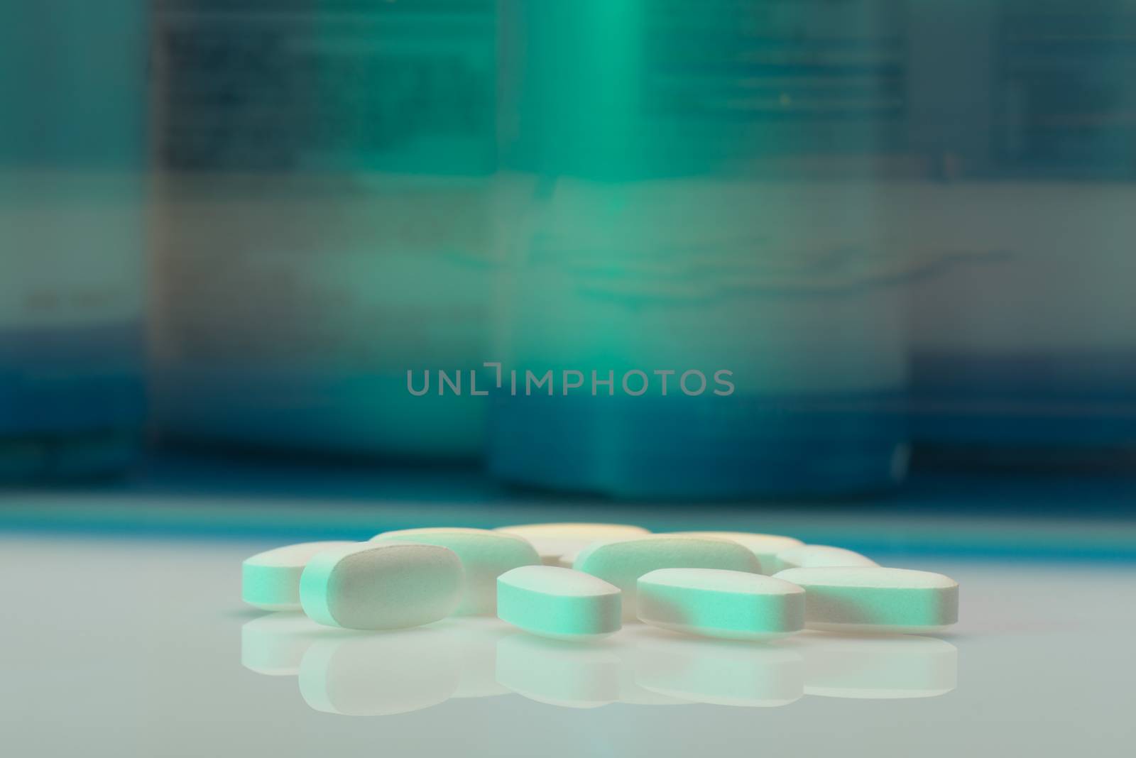 Drug, medicine or supplement pills on table with color effects. Health concept. Medical background.