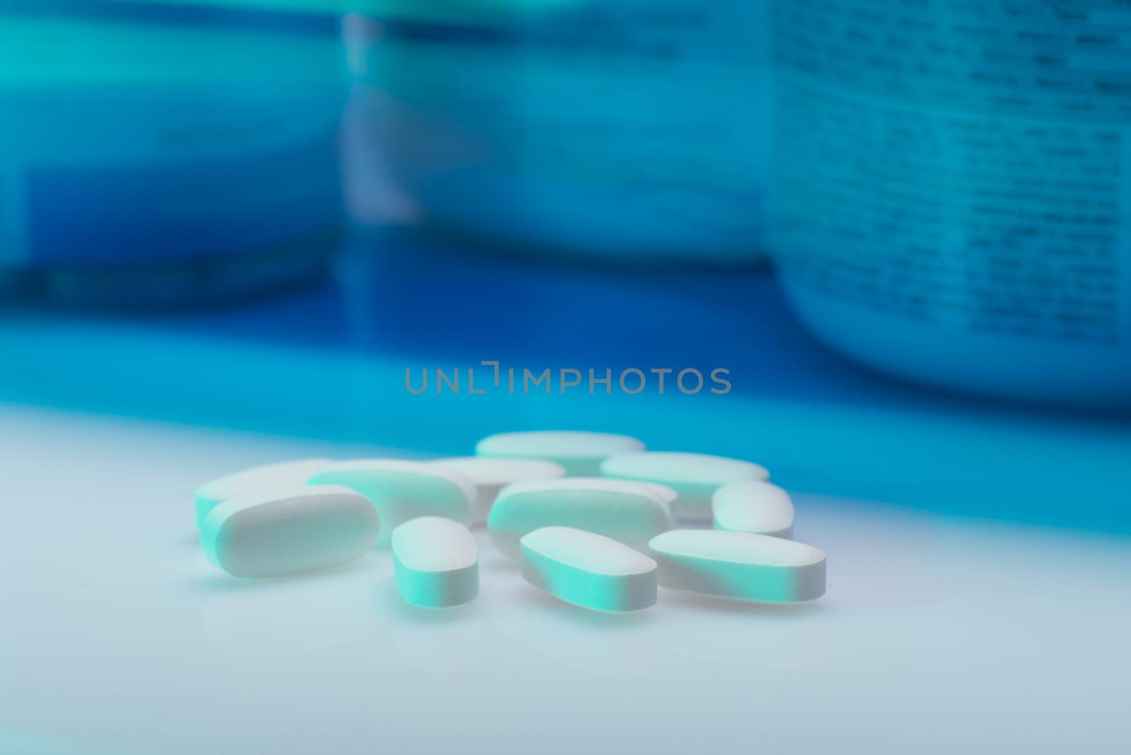 Drug, medicine or supplement pills on table with color effects. Health concept. Medical background.