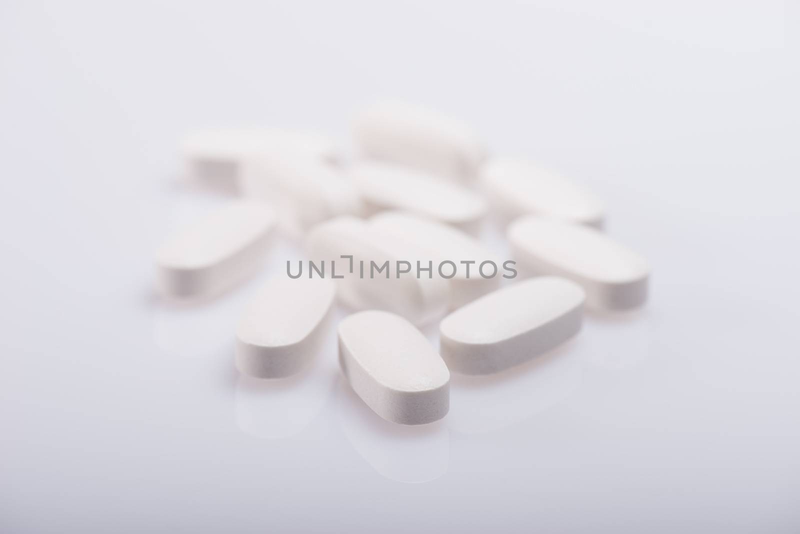 Drug, medicine or supplement pills on table with color effects. Health concept. Medical background.