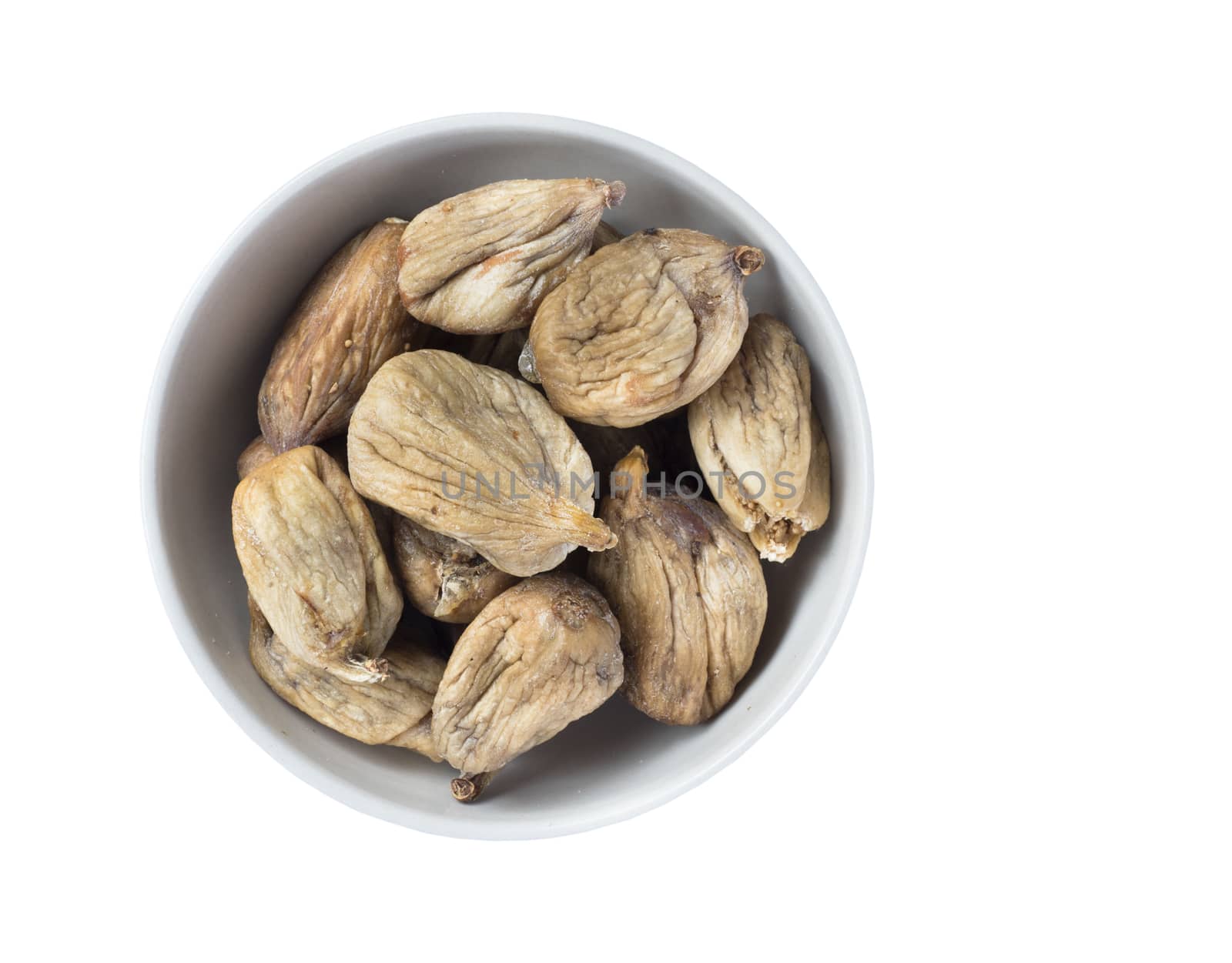 Full bowl of dried figs isolated on white background. Top view.