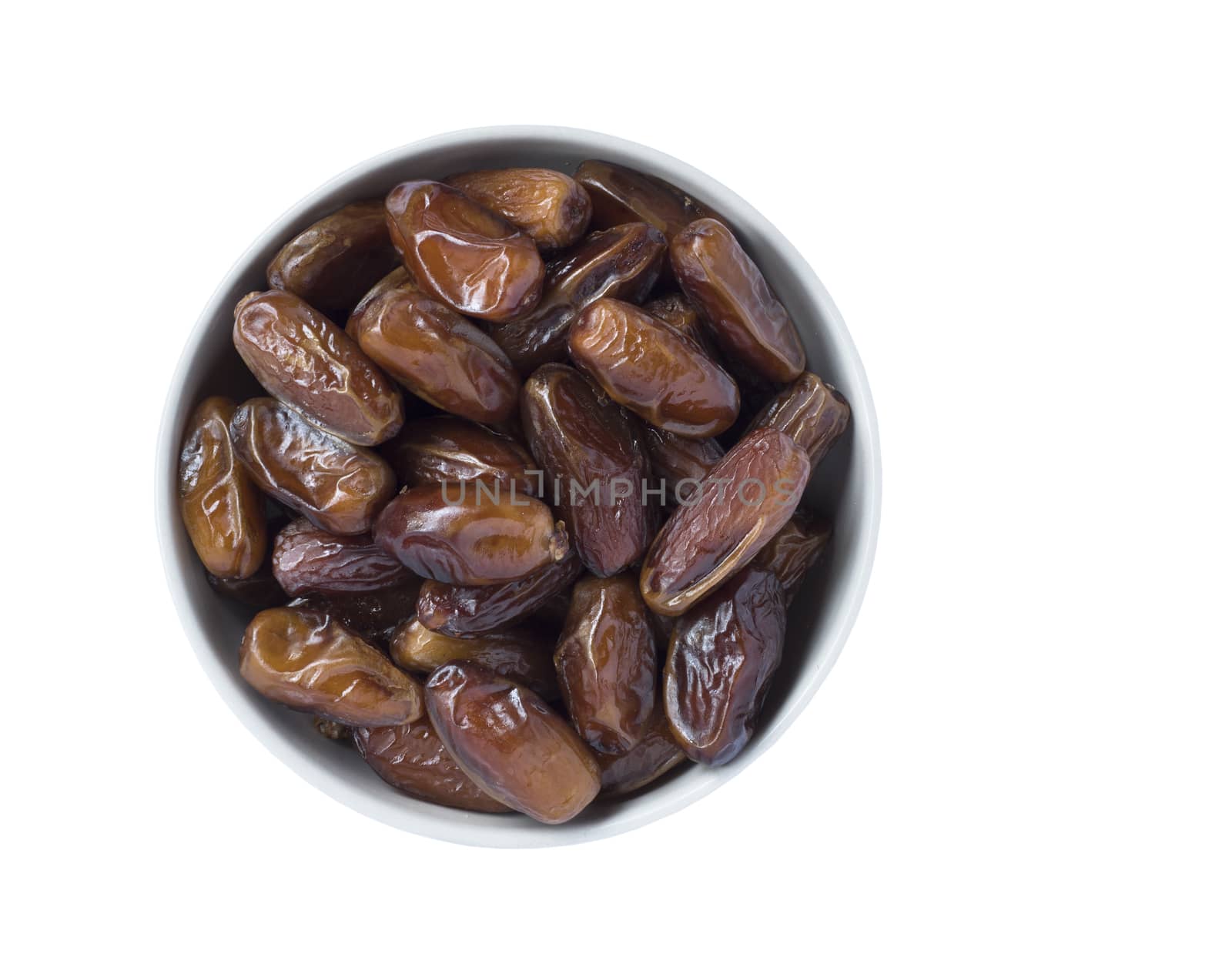 Full bowl of dried dates isolated on white background. Top view.