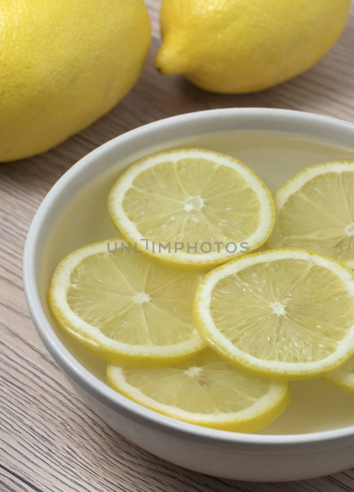 Lemon slices in a bowl with water. Close up view.