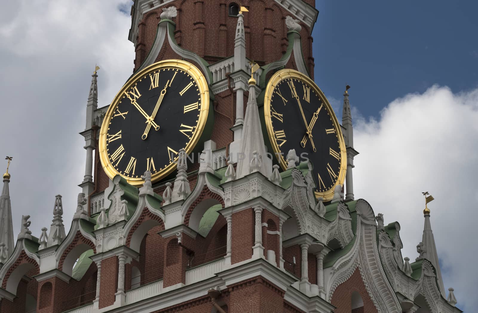 Moscow, Russia, View on Spasskaya Tower of the Moscow Kremlin with a clock, on against cloudy sky.