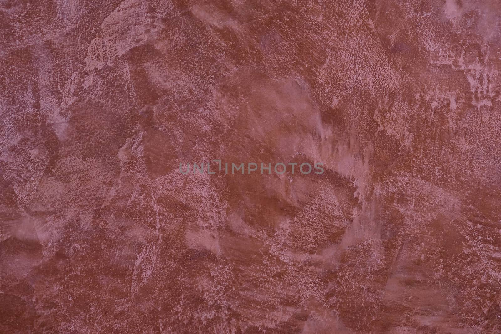 painted,  layered surface of the wall in magenta and red  tones
