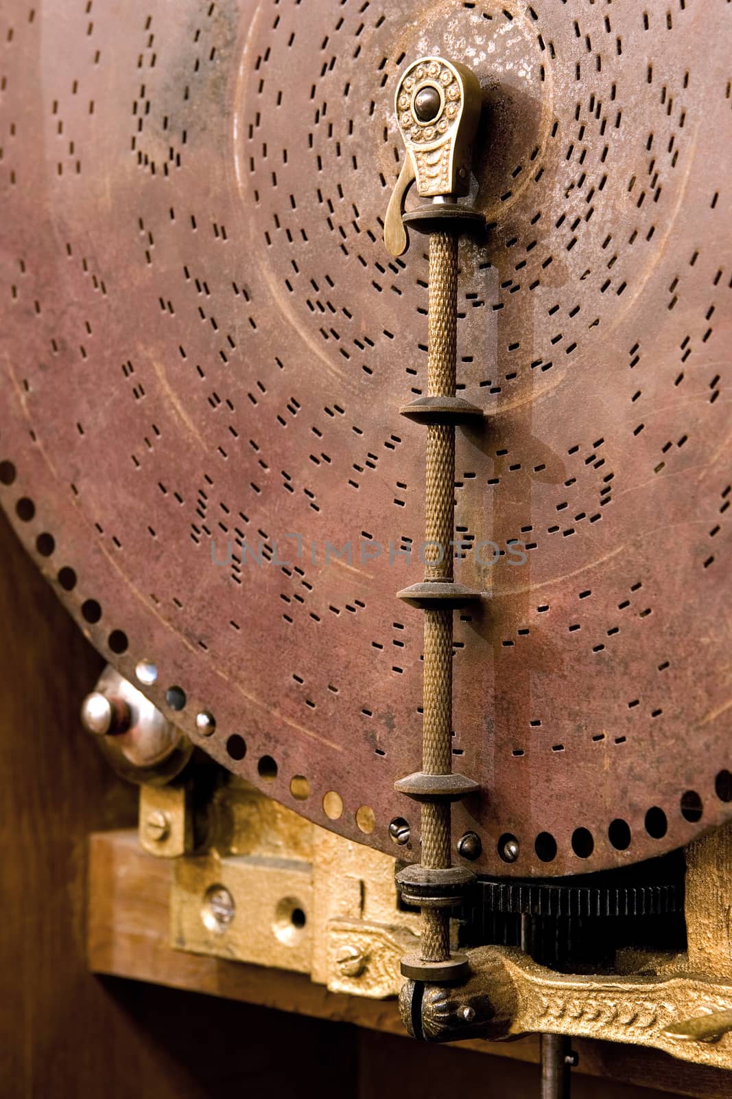  an ancient musical box, close up of disk with holes