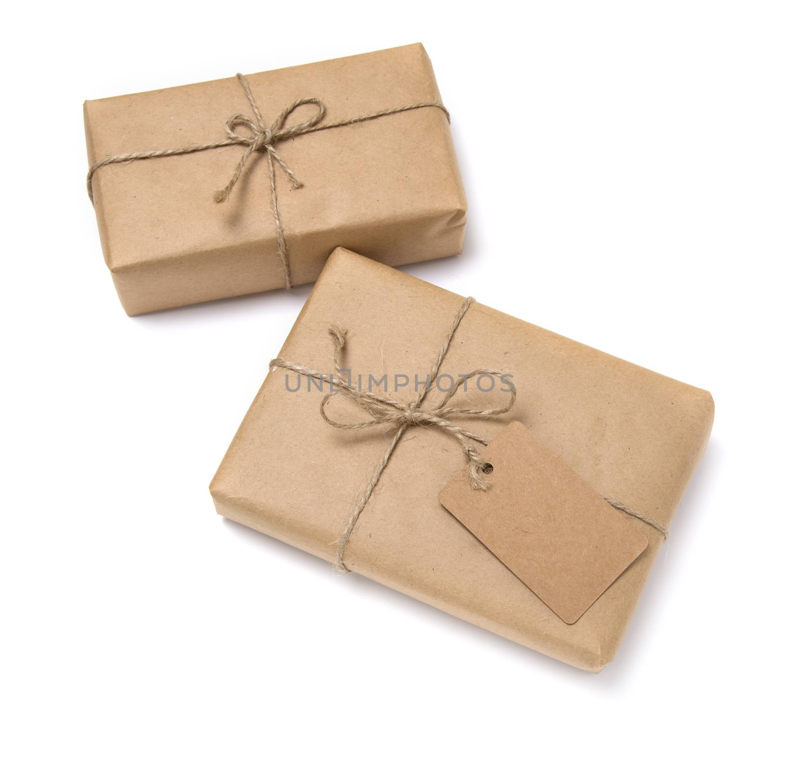 Christmas gift box wrapped in kraft paper. Isolated on white background