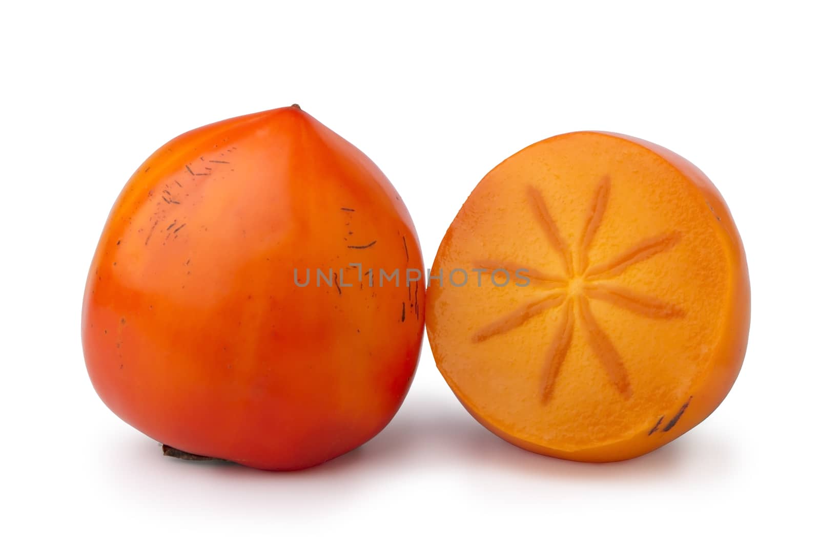ripe persimmon, a whole fruit and a half, isolated on white