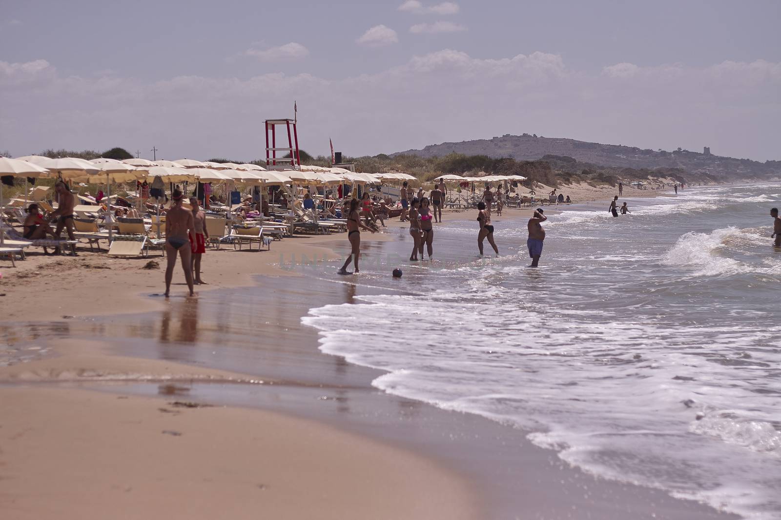 People are walking on the beach in Marina di Butera