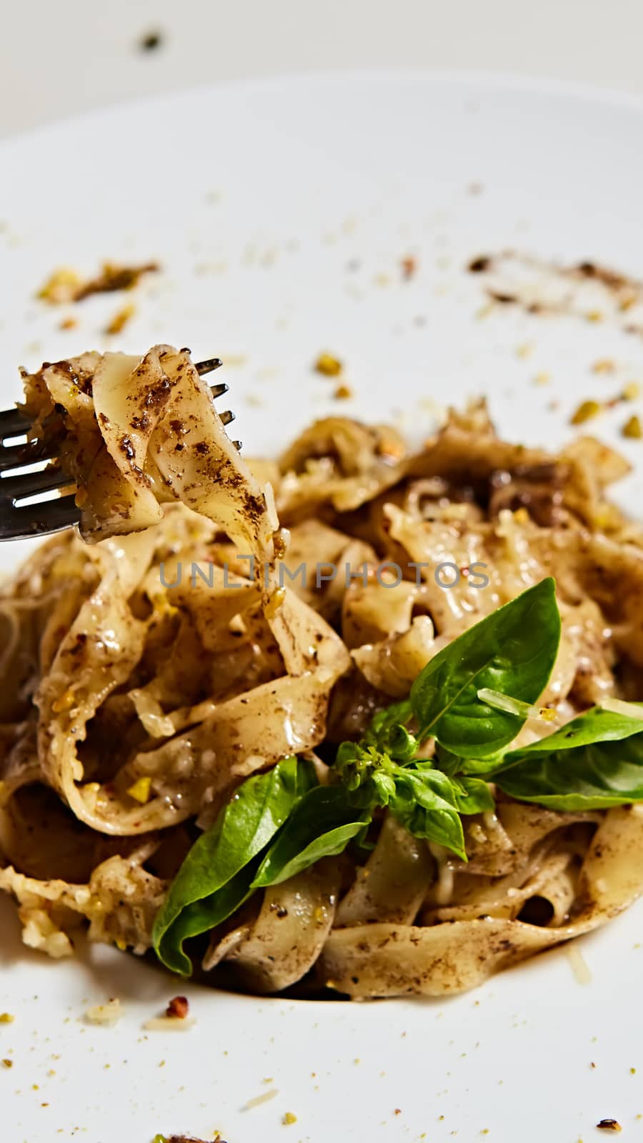 Tagliatelle with mushrooms and decorated with basil leaves. by sarymsakov
