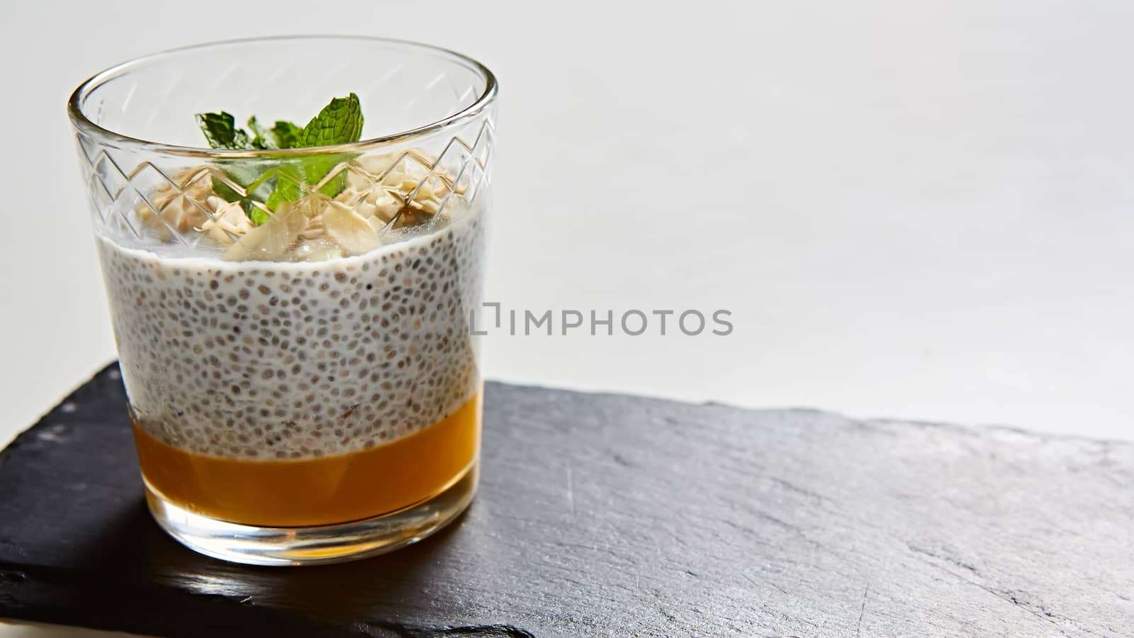 Mango yogurt with chia seeds for healthy breakfast on a white background by sarymsakov