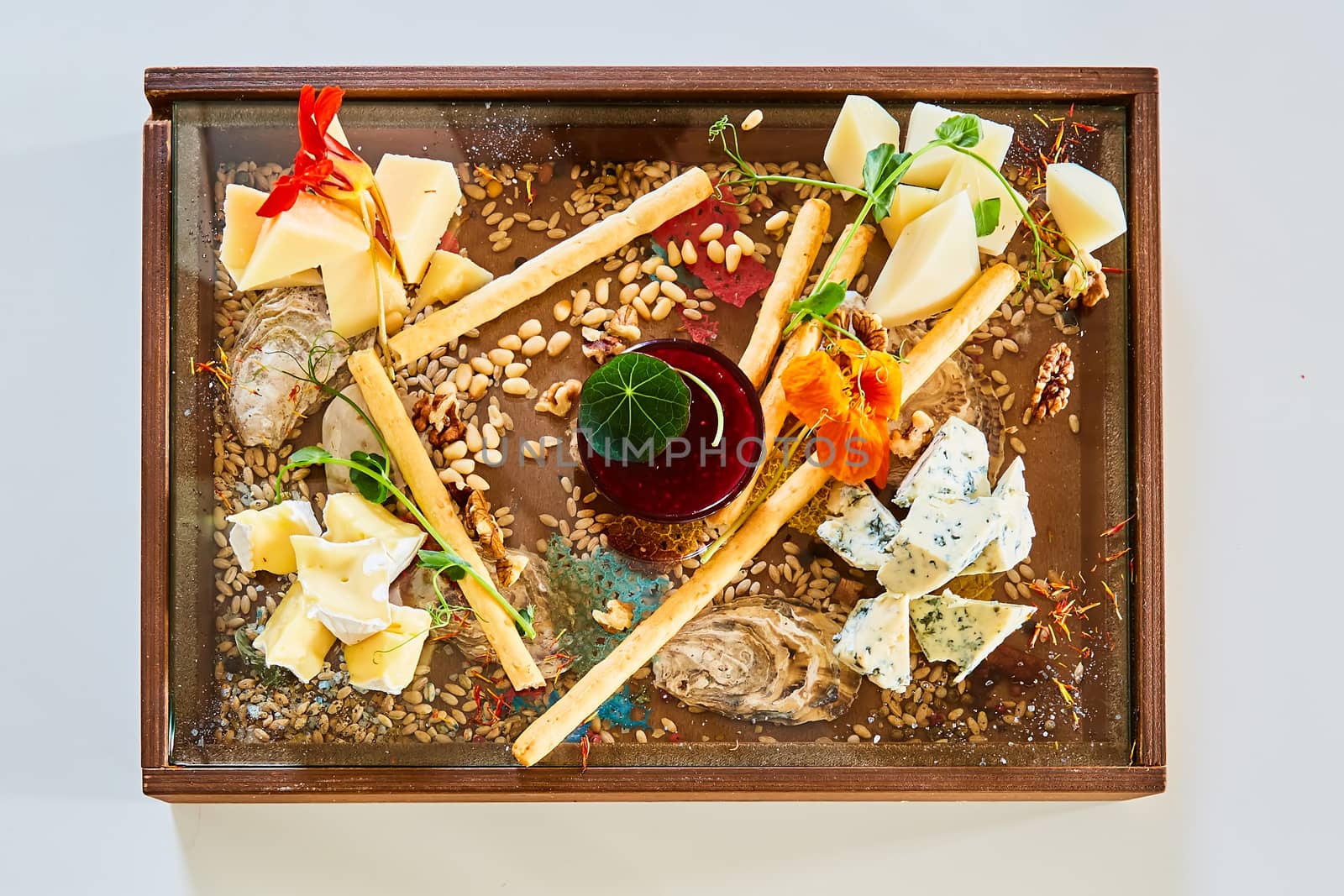 Cheese selection on wooden rustic board. Cheese platter with different cheeses on wood